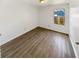 Empty bedroom featuring laminate flooring and a window allowing natural light at 1958 Brittania Cir, Woodstock, GA 30188