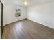 Cozy bedroom with wood-look flooring and a window overlooking the yard at 1958 Brittania Cir, Woodstock, GA 30188
