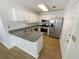 Well-lit kitchen with stainless steel appliances, gray countertops, and ample cabinet space at 1958 Brittania Cir, Woodstock, GA 30188