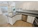Bright, open kitchen with stainless steel appliances, gray countertops, and modern fixtures at 1958 Brittania Cir, Woodstock, GA 30188