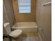 Bathroom featuring a standard tub and shower with tan tile and neutral walls at 2689 Rollingwood Se Ln, Atlanta, GA 30316