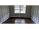 Bedroom with dark hardwood floors, paneled walls, and natural light from the window at 2689 Rollingwood Se Ln, Atlanta, GA 30316