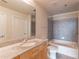 Bathroom featuring a granite vanity top, grey tiled shower, and a bathtub at 361 17Th St # 1516, Atlanta, GA 30363