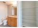 Well-lit bathroom featuring a granite-topped vanity, toilet, and an open door to a closet with shelves at 361 17Th St # 1516, Atlanta, GA 30363