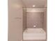 Modern bathroom with a white tiled shower-tub combination and a chrome towel rack at 361 17Th St # 1516, Atlanta, GA 30363