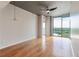 Bright bedroom with hardwood floors, bare concrete pillars and ceiling, and sliding glass windows offering city views at 361 17Th St # 1516, Atlanta, GA 30363