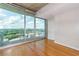 Bedroom featuring floor to ceiling windows with hardwood floors and city views at 361 17Th St # 1516, Atlanta, GA 30363