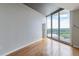 Bright bedroom with hardwood floors, neutral paint, and floor-to-ceiling windows with sliding doors to the balcony at 361 17Th St # 1516, Atlanta, GA 30363