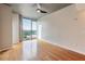 Bright bedroom with hardwood floors, bare concrete pillars and ceiling, and sliding glass windows offering city views at 361 17Th St # 1516, Atlanta, GA 30363