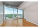 Sun-filled bedroom features hardwood floors, floor-to-ceiling windows, and a private balcony with stunning city views at 361 17Th St # 1516, Atlanta, GA 30363