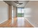 Bright bedroom with hardwood floors, bare concrete pillars and ceiling, and sliding glass windows offering city views at 361 17Th St # 1516, Atlanta, GA 30363