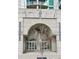 Modern building entrance showcasing an arch design, glass doors, and concrete walls, complemented by a young tree at 361 17Th St # 1516, Atlanta, GA 30363