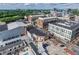 High-angle perspective of mixed-use development featuring a blend of retail, parking, and streetscape under a partly cloudy sky at 361 17Th St # 1516, Atlanta, GA 30363