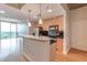Stylish kitchen featuring wooden cabinets, a black backsplash, and stainless appliances, situated next to a bright living area at 361 17Th St # 1516, Atlanta, GA 30363