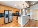 Contemporary kitchen features stainless steel appliances, wooden cabinets, black backsplash, and a stylish island at 361 17Th St # 1516, Atlanta, GA 30363