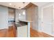 Modern kitchen boasts wooden cabinets, a black backsplash, and granite countertops, adjacent to an open living space at 361 17Th St # 1516, Atlanta, GA 30363