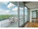 Modern living room features a balcony with city views, hardwood floors, and floor-to-ceiling glass sliding doors at 361 17Th St # 1516, Atlanta, GA 30363