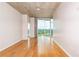 Bright living room with hardwood floors, concrete ceiling, large windows offering a view, and neutral-colored walls at 361 17Th St # 1516, Atlanta, GA 30363