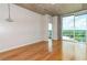 Inviting living area featuring hardwood floors, a concrete ceiling, expansive windows, and neutral-toned walls at 361 17Th St # 1516, Atlanta, GA 30363