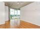 Spacious living room with hardwood floors, concrete ceilings, large windows, and freshly painted white walls at 361 17Th St # 1516, Atlanta, GA 30363