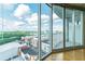 Bright living room with floor-to-ceiling windows showcasing a panoramic city view and access to an outdoor balcony at 361 17Th St # 1516, Atlanta, GA 30363