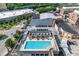 Aerial shot of the community pool, showcasing lounge chairs, landscaping, and nearby retail spaces under a sunny sky at 361 17Th St # 1516, Atlanta, GA 30363