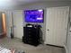 Bedroom featuring a large wall-mounted television, dresser, and carpeted floors at 3802 Macland Rd, Hiram, GA 30141