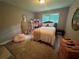 Neutral-toned bedroom with large window and furniture pieces at 3802 Macland Rd, Hiram, GA 30141
