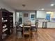 Cozy dining area with wood floors, stylish chairs, and view to the kitchen with white cabinetry at 3802 Macland Rd, Hiram, GA 30141