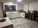 Basement kitchen with white cabinets, stainless steel sink, and decorative accessories at 3802 Macland Rd, Hiram, GA 30141