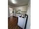 Functional kitchen featuring white cabinets, laminate countertops and laminate flooring at 512 Alpine Way, Marietta, GA 30062