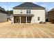 View of the back of the house with a patio overlooking the large backyard at 7644 Watson Cir, Locust Grove, GA 30248