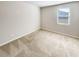 A simple bedroom features soft carpet and a bright window at 7644 Watson Cir, Locust Grove, GA 30248