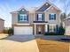 Charming two-story home featuring a spacious driveway and well-maintained lawn at 7644 Watson Cir, Locust Grove, GA 30248