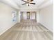 Spacious living room featuring tray ceilings, ceiling fan and neutral walls and carpet at 7644 Watson Cir, Locust Grove, GA 30248