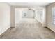 View of the living room featuring neutral walls and carpet and plentiful natural light at 7644 Watson Cir, Locust Grove, GA 30248