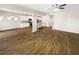 Open-concept living room flowing into a modern kitchen with hardwood floors at 7644 Watson Cir, Locust Grove, GA 30248