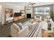 Bright living room featuring a fireplace, plush seating, and hardwood floors at 7644 Watson Cir, Locust Grove, GA 30248