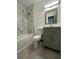 A bathroom with updated tile and shower features and a newer vanity at 8325 Attleboro Dr, Jonesboro, GA 30238