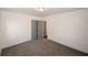 A bedroom featuring neutral colored walls, carpet, and doors with a ceiling light at 8325 Attleboro Dr, Jonesboro, GA 30238