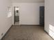 Bedroom featuring plush carpeting, neutral paint, and a view of the modern en-suite bathroom at 8325 Attleboro Dr, Jonesboro, GA 30238