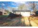 Back exterior view of a house with a wooden porch/balcony that overlooks the backyard with trees at 8325 Attleboro Dr, Jonesboro, GA 30238