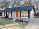 Cozy brick home with an orange front door, large front window, and basketball hoop at 8325 Attleboro Dr, Jonesboro, GA 30238