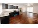 Charming kitchen features black cabinets, stainless appliances, and an adjacent living area at 8325 Attleboro Dr, Jonesboro, GA 30238
