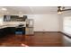 Kitchen with stainless steel appliances, black cabinets, and views to the open floor plan at 8325 Attleboro Dr, Jonesboro, GA 30238