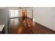 Bright living area showcasing hardwood floors, stainless steel appliances, and a modern refrigerator at 8325 Attleboro Dr, Jonesboro, GA 30238