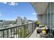 Private balcony with views of the city, patio furniture, and fresh flowers at 1080 Peachtree Ne St # 2309, Atlanta, GA 30309