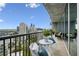 Condo balcony with city views, seating, and sliding glass doors to indoor space at 1080 Peachtree Ne St # 2309, Atlanta, GA 30309