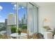 Condo balcony with city skyline view, table and chairs, and sliding glass doors to indoor space at 1080 Peachtree Ne St # 2309, Atlanta, GA 30309
