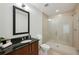 Well-lit bathroom with a vanity sink, neutral paint, and a large glass shower at 1080 Peachtree Ne St # 2309, Atlanta, GA 30309